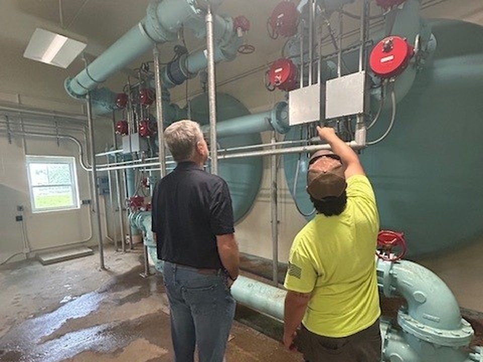 ETS operators inspecting piping in a pump station